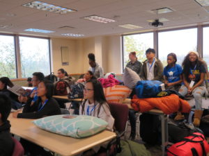 Students in classroom with sleeping bags
