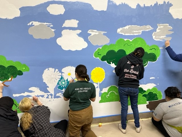 AmeriCorps volunteers painting a mural