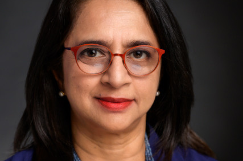 Professional Headshot Of Woman With Glasses, Wearing A Necklace