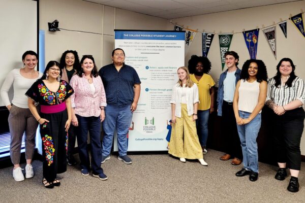 Group Photo Of College Access Team Posed In Front Of The College Possible Student Journey Retractable Banner. From Left To Right: Cady, Lizbeth, Dorothy, Dr. Susan Toohey, Chris, Katie, Gwen, Chase, Mackenzie, And Bre.