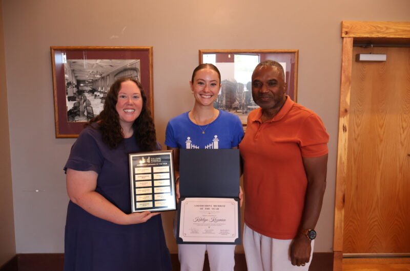 Katie Smiling, Holding Her Award With Supervisor Mallory On Her Left, And Senior Executive Director Arvin Frazier On Her Right.