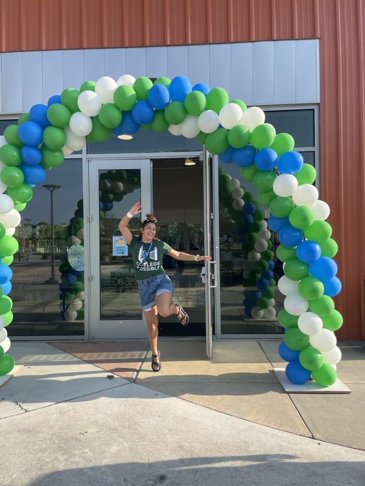 Sara, smiling and welcoming, prepares to greet families at our summer 2024 FAFSA block party