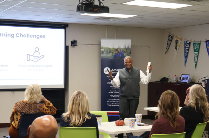 Senior Executive Director Arvin Frazier Smiling While Giving A Presentation At The Community Partners Open House.