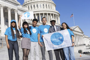 College Possible student stands with his peers in front of the United States Capitol.