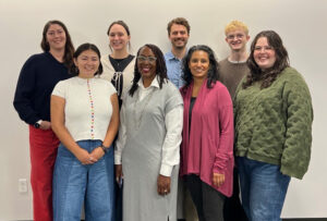The College Possible Washington team and Tisha Held are photographed together at the BECU headquarters. Staff are posing together in two rows against a plain white wall, with Tisha Held pictured among them.