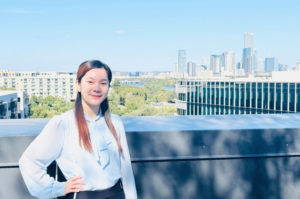 Maryrose standing on a balcony overlooking the Austin, Texas Skyline
